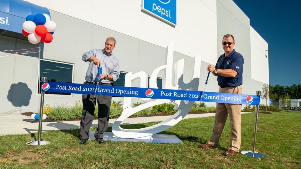 A ribbon cutting at a new Pepsi warehouse in Indy. PBNA Div. Pres. Rich Tompkin, right (courtesy:Josh Smith of Creative World Films)